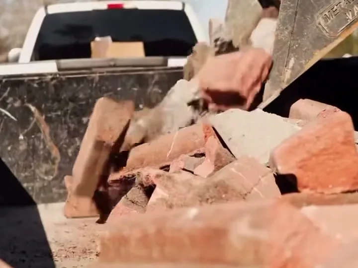 Brick and concrete demolition debris loaded for haul-off