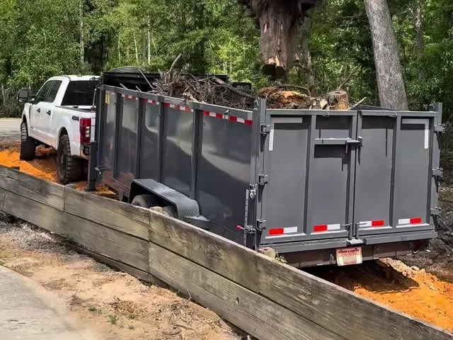 Stump being loaded into the dump trailer for haul-off